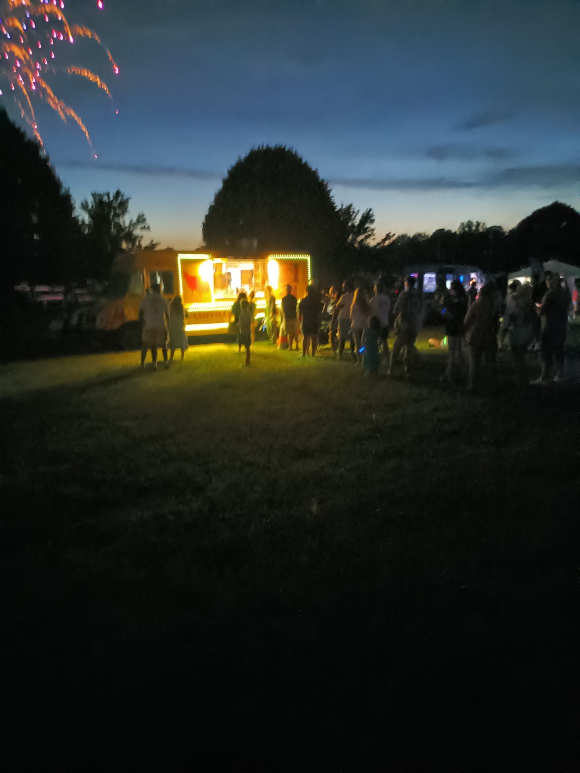 Customers gathered at the illuminated Dirty Chicken truck at night